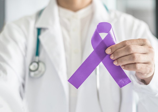 person holding purple ribbon