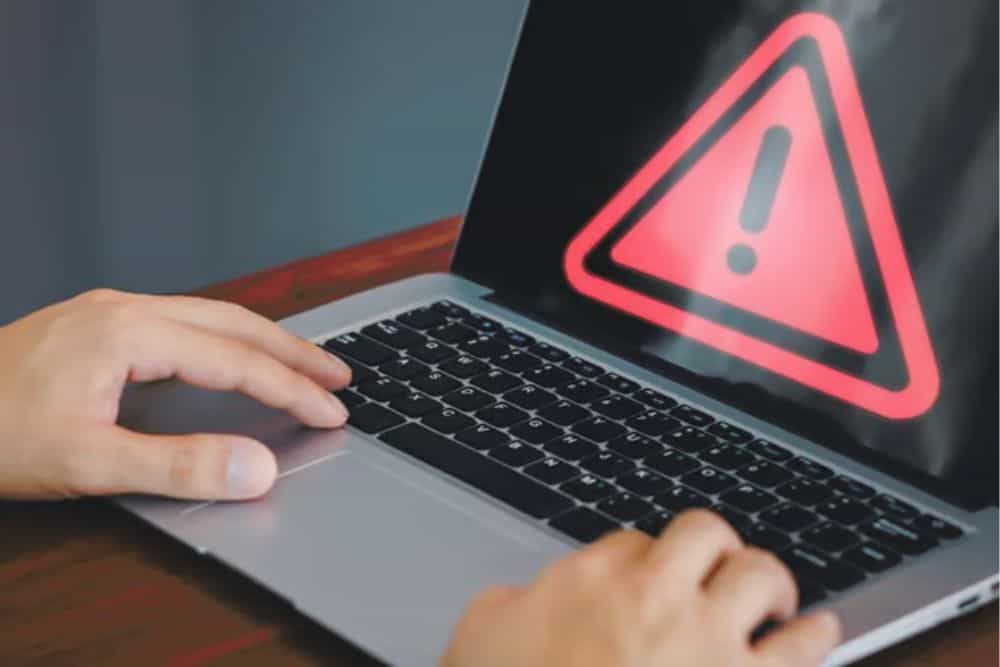Computer laptop with triangle caution warning sign