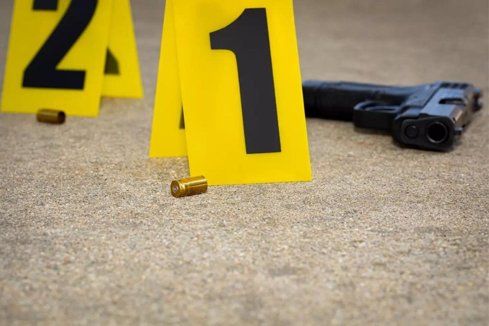 Gun and gun shell casing at crime scene