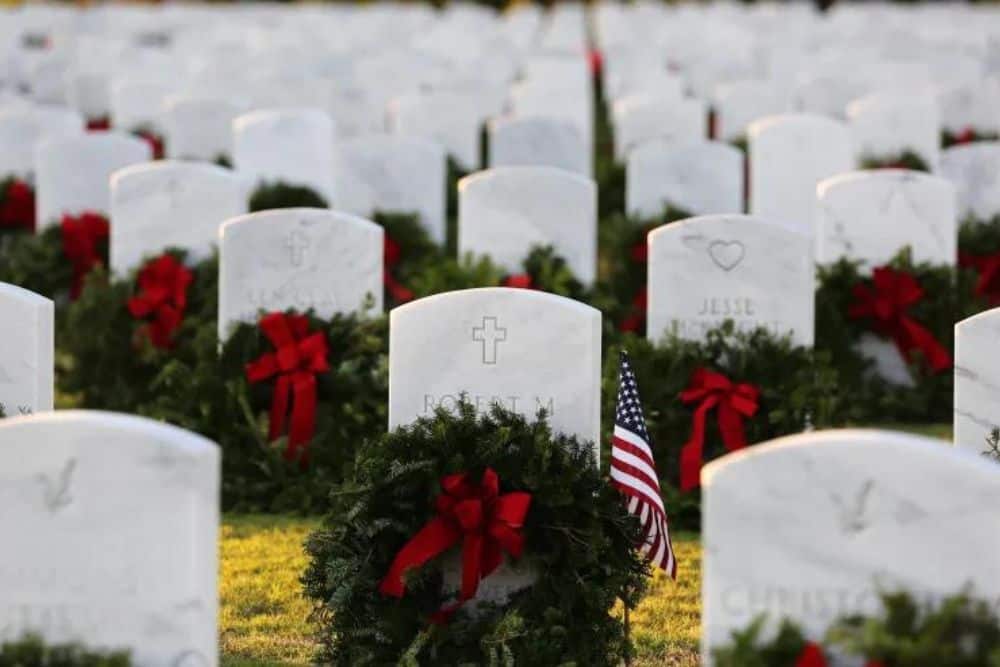 Wreaths Across America laid out on each headstone at an American military veterans cemetery