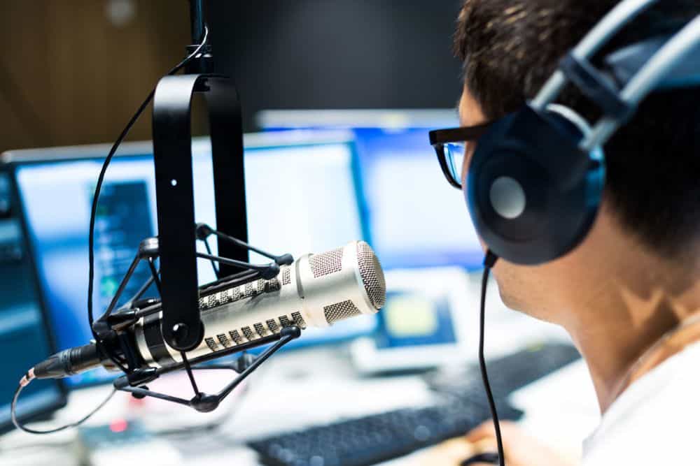 A man works in modern broadcast studio