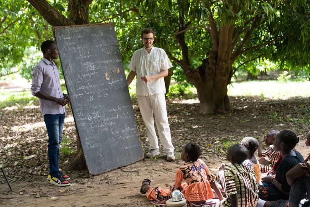 A veteran volunteer teaching the kids.